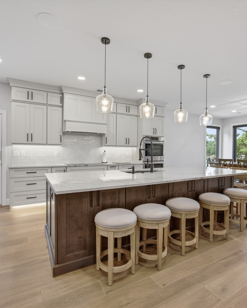 Custom Lake of the Ozarks kitchen with white cabinetry, wood island and lake view by Ragan Cabinets.