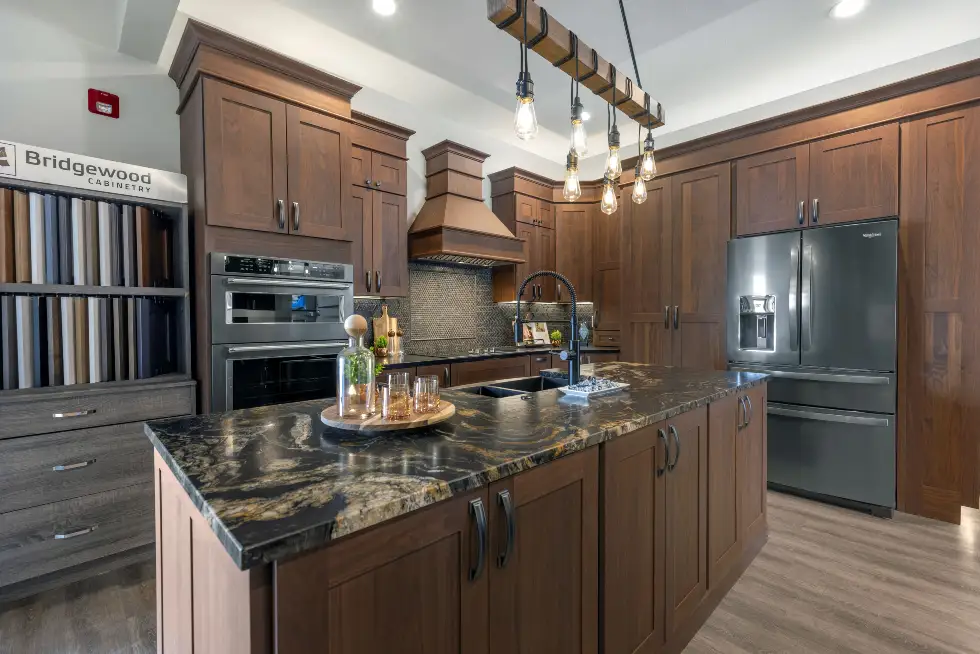 Ragan Cabinets showroom in Eldon, Missouri featuring Bridgewood cabinetry, wood cabinet displays, stone countertops and kitchen design options.